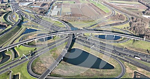 Top down aerial view from drone on a modern traffic intersection of multiple lane highway road.