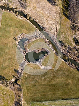 Top down aerial view with early spring meadows and river