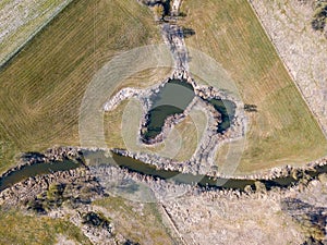Top down aerial view with early spring meadows and river