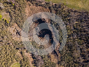 Top down aerial view with early spring meadows and river