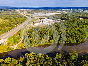 Top-down aerial view of green forest, river and freeway