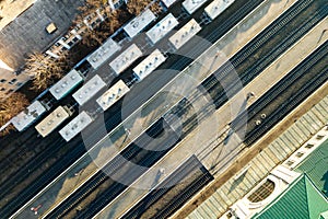 Top down aerial view of many cargo train cars on railway tracks