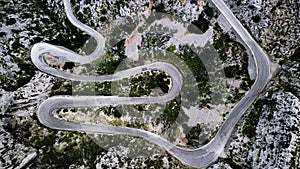 A top-down aerial view on mountainous curvy road Nus de Se Calobra