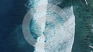 Top down aerial view of the ocean giant waves, foaming and splashing slow-motion