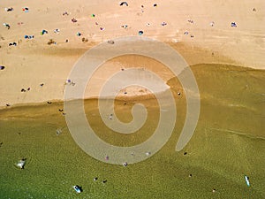 Top down aerial view of people on a busy sandy beach Broad Haven South, Wales