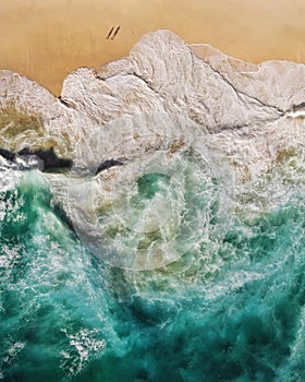Top Down Aerial View of Turquoise Waves Breaking on the Shore of Tropical Sand Beach