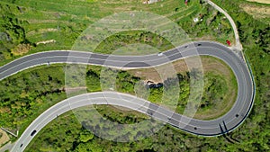 TOP DOWN: Cars and motorbikes drive along the scenic switchback road in Slovenia