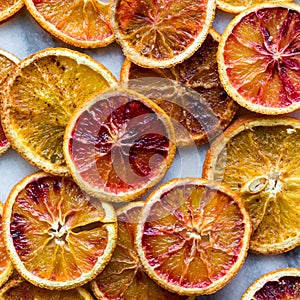 Top down close up view of various spiced dried orange slices.