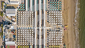 Top down drone aerial view of the umbrellas and gazebos on Italian sandy beaches. Riccione, Italy. Adriatic coast