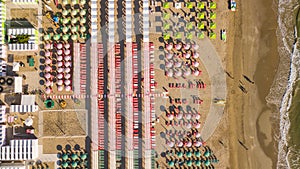 Top down drone aerial view of the umbrellas and gazebos on Italian sandy beaches. Riccione, Italy. Adriatic coast photo