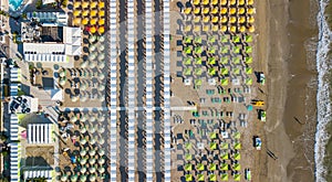 Top down drone aerial view of the umbrellas and gazebos on Italian sandy beaches. Riccione, Italy. Adriatic coast photo