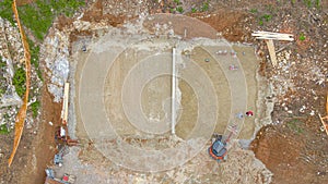 TOP DOWN: Drone point of view of workers levelling the concrete foundation.