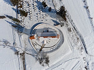 Top down drone view, small catholic church at wintertime