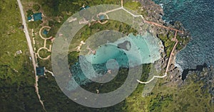 Top down of limpid turquoise lake with designed ways on green valley in aerial. Nobody Asia nature photo