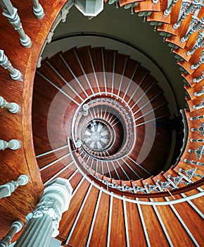 Top down look to Old spiral staircase with ornaments in tenement