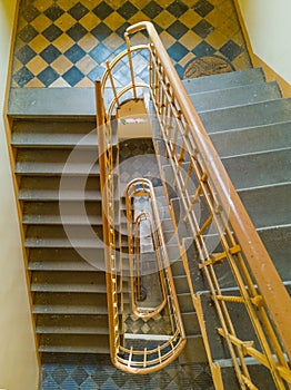 Top down look to spiral staircase with yellow railing