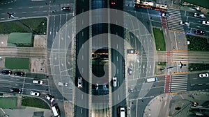 Top down night city roads with cars driving aerial view. Nightly urban cityscape with modern skyscrapers. Majestic cityscape lit