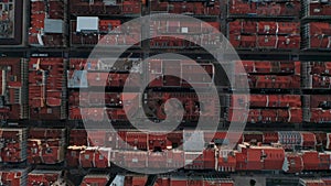 Top down overhead aerial view of colorful red rooftops of houses in urban city center of Portugal, Lisbon. Rows of