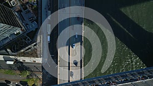 Top down panning footage of vehicles driving on multilane trunk road on riverbank. Fly over Manhattan Bridge. New York