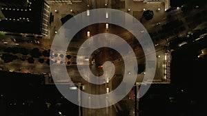 Top down panning footage of vehicles driving through road intersection in night city. Berlin, Germany