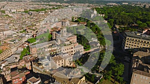 Top down panning view of buildings in urban borough. Revealing vehicles driving on bridge over Tiber river. Rome, Italy