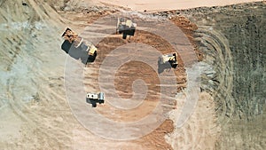 Top down shot footage. Excavator loads sand into mining truck. Mining Excavator loads sand rock into haul truck