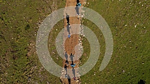 Top down shot of a group of people backpacking on a trail path