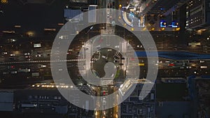 Top down shot of vehicles on multilane main road passing through intersection in night city. Kyoto, Japan