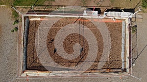 Top-down view of a beach volleyball court without people on a sunny summer day.