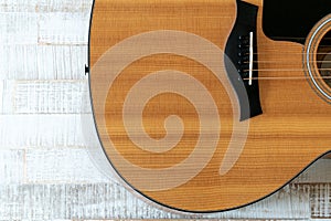 Top down view of beautiful acoustic guitar on a rustic white wood background