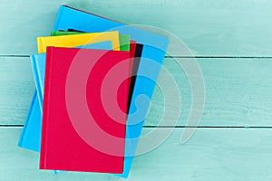 Top down view of blank books on blue table