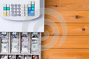 Top down view on cash register full of coins