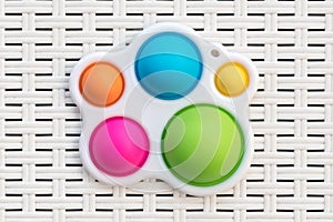 Top down view on a colorful Symple Dimple Fidget toy