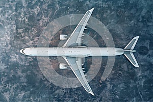 Top down view on comercial airplane docking in terminal on the airport apron, waiting for services maintenance