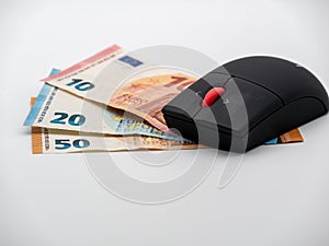 Top down view on Computer mouse on money bills