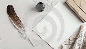 Top down view of a feather quill, ink bottle, notebook, and paper on a desk surface background
