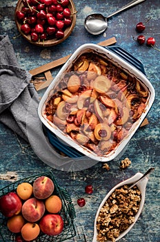 A top down view of a freshly baked stone fruit cobbler ready to be dished out.