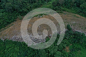 Top down view of a garbage landfill, showing the loads of garbage being dumped