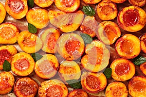 Top down view of healthy and delicious fruity dessert with half sliced peaches, baked with honey, cinnamon, butter and fresh mint