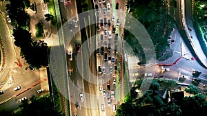 Top down view of heavy traffic on toll road gateway at night rush hour in Jakarta city, Indonesia. Shot in 4k resolution