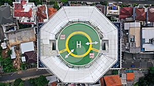 Top down view of helicopter landing pad on the roof of modern skyscraper in Jakarta city