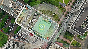 Top down view of a helipad on the roof of a modern skyscraper