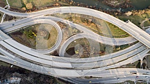 Top down view of highway multi level junction road with moving cars. View of traffic jam passing through city center