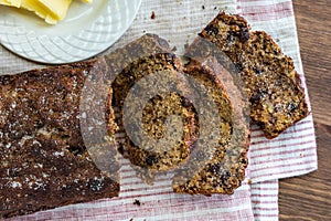 Top down view of homemade banana bread sliced and ready to serve with butter.