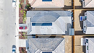 Top Down view of a house with a solar panel on it and a empty backyard