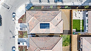 Top Down view of a house with a solar panel on it and a empty backyard