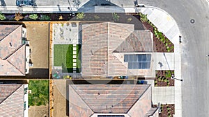 Top Down view of a house with a solar panel on it and a empty backyard