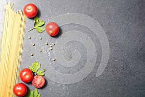 Top Down View On Kitchen Ingredients Like Noodles, Tomatoes, Parsley Or Spices On Slate Stone, With Copy Space