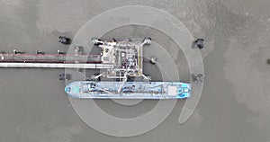 Top down view on landing port for bulk carrier ships. Oil tanking , Loading and unloading of inland waterway vessels