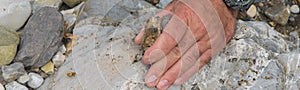 Top down view of man hand researching minerals. Geologic occupation in the nature